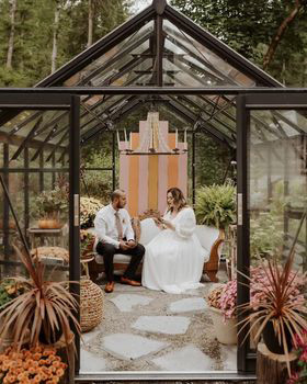 autumn greenhouse with bride and groom